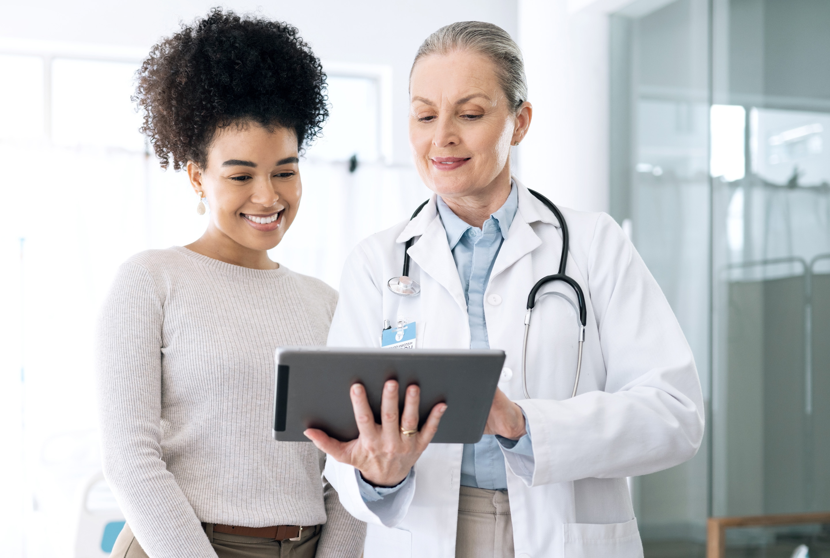 Doctor showing a person info on a tablet