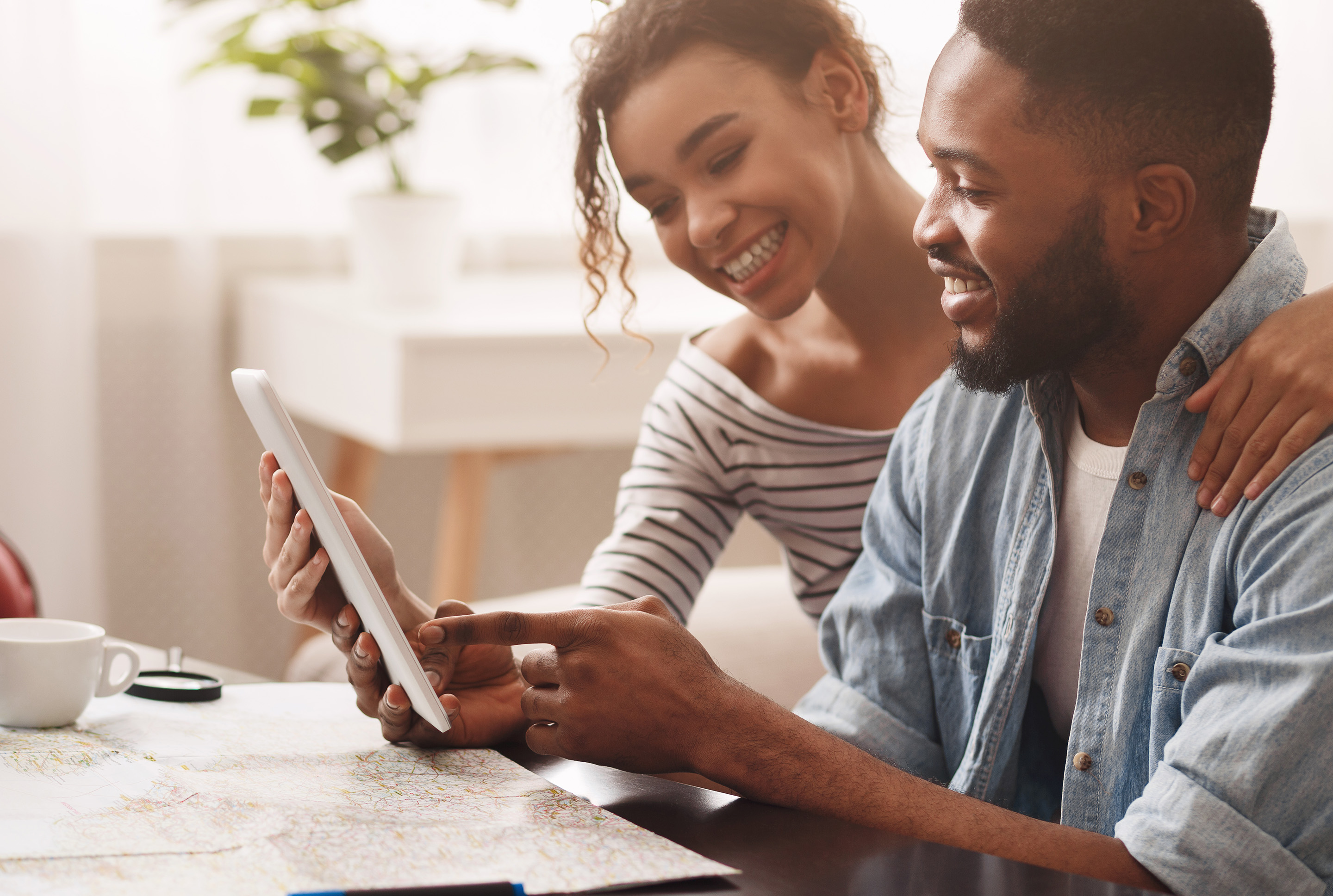 man and woman looking at a tablet together