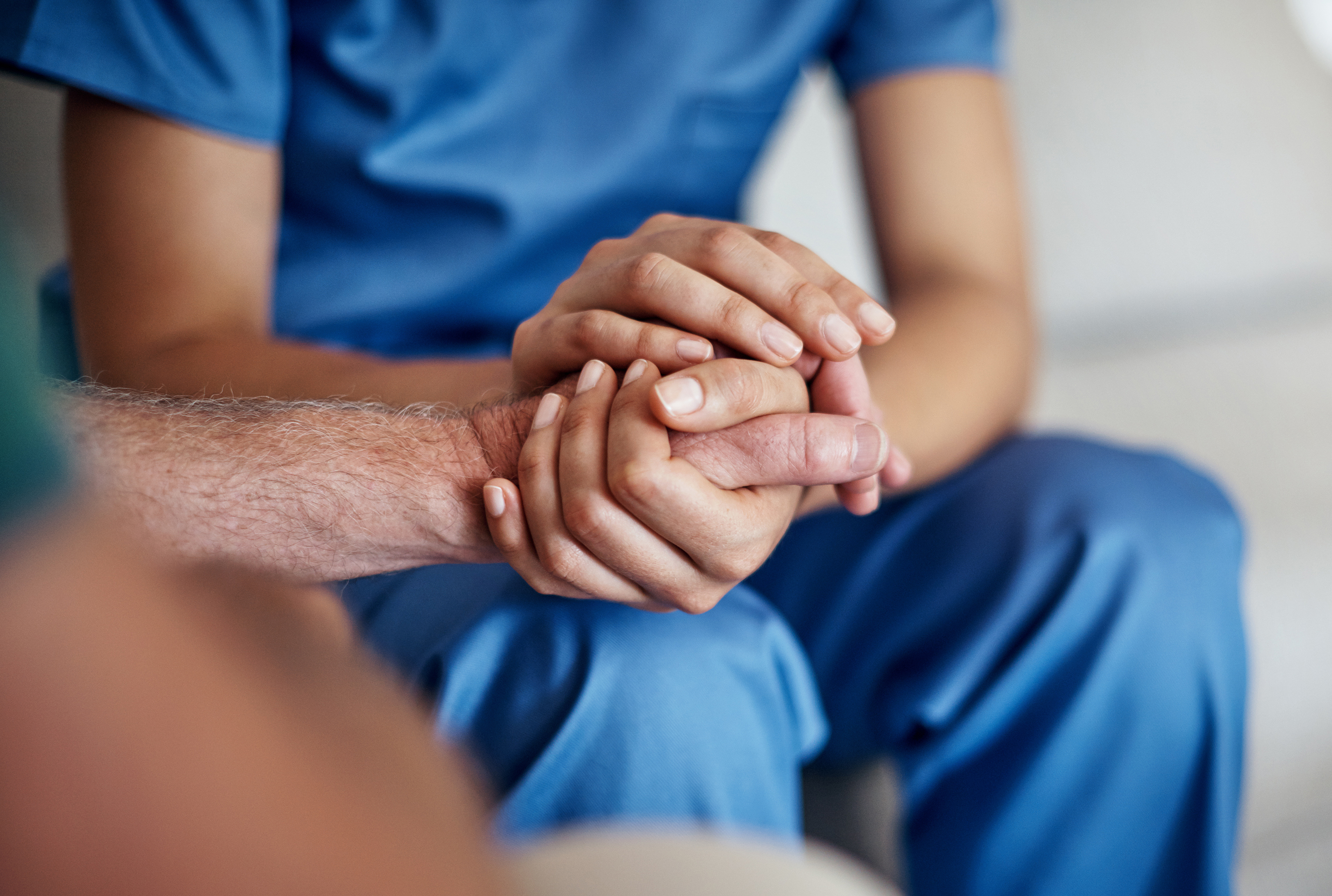 doctor holding patients hand for support