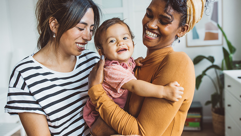 people holding a smiling baby